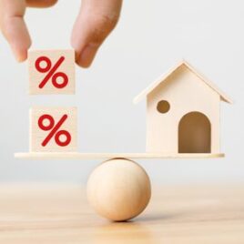Wooden house on a balance with percentage blocks – Symbolising mortgage rates and financial advice for home buyers Wooden house on a balance with percentage blocks – Symbolising mortgage rates and financial advice for home buyers