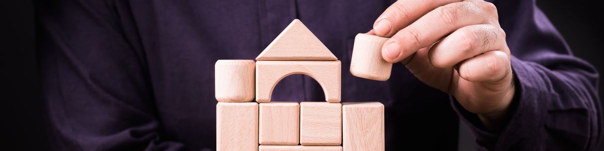 A Man's Home is His Castle - Man Building Blocks Castle at Alman Partners True Wealth Mackay