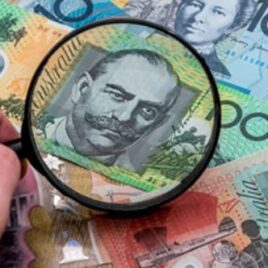 Magnifying glass focusing on an Australian banknote – Financial advice on scrutinising investments and making informed financial decisions. Magnifying glass focusing on an Australian banknote – Financial advice on scrutinising investments and making informed financial decisions.