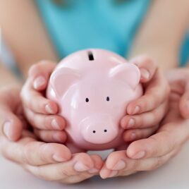 Hands holding a piggy bank, symbolising smart financial advice and saving strategies Hands holding a piggy bank, symbolising smart financial advice and saving strategies