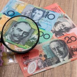 Magnifying glass focusing on an Australian banknote – Financial advice on scrutinising investments and making informed financial decisions. Magnifying glass focusing on an Australian banknote – Financial advice on scrutinising investments and making informed financial decisions.