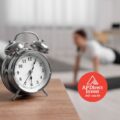 Live longer, live richer! - A vintage alarm clock with a fitness setting in the background, emphasizing financial advice on time-sensitive investments
