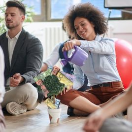 Smiling woman watering a money plant, symbolising financial growth with expert financial adviser guidance. Smiling woman watering a money plant, symbolising financial growth with expert financial adviser guidance.